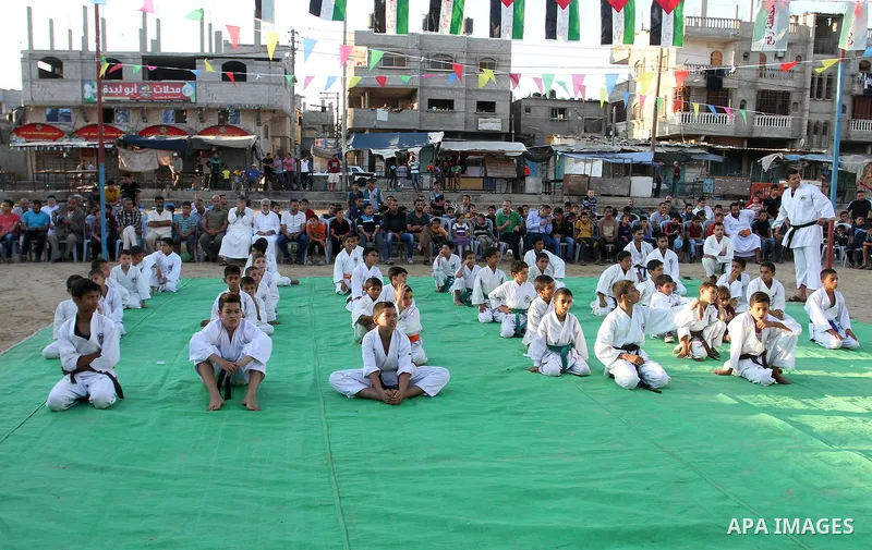 Palestinian children take part in a Karate graduation session at a club in Rafah, in the southern Gaza strip, on Oct. 28, 2016. Photo by Abed Rahim Khatib