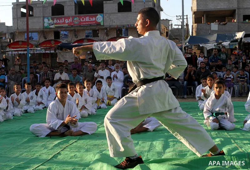 Palestinian children take part in a Karate graduation session at a club in Rafah, in the southern Gaza strip, on Oct. 28, 2016. Photo by Abed Rahim Khatib