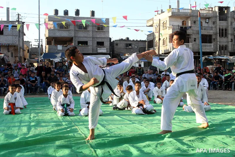 Palestinian children take part in a Karate graduation session at a club in Rafah, in the southern Gaza strip, on Oct. 28, 2016. Photo by Abed Rahim Khatib