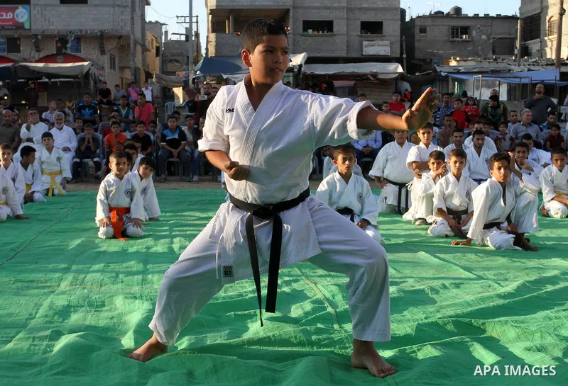 Palestinian children take part in a Karate graduation session at a club in Rafah, in the southern Gaza strip, on Oct. 28, 2016. Photo by Abed Rahim Khatib