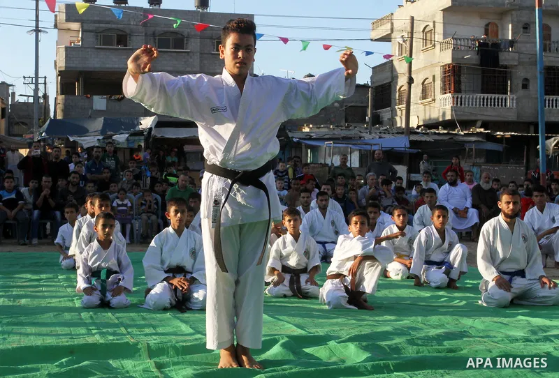 Palestinian children take part in a Karate graduation session at a club in Rafah, in the southern Gaza strip, on Oct. 28, 2016. Photo by Abed Rahim Khatib