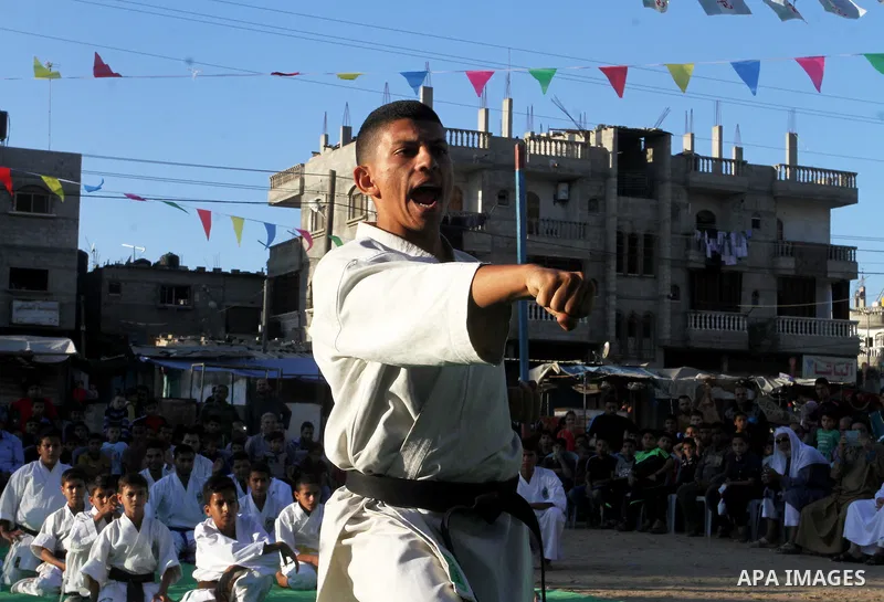 Palestinian children take part in a Karate graduation session at a club in Rafah, in the southern Gaza strip, on Oct. 28, 2016. Photo by Abed Rahim Khatib
