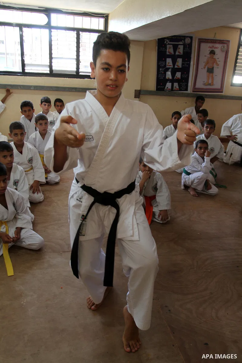 Palestinian children take part in a Karate graduation session at a club in Rafah, in the southern Gaza strip, on Oct. 28, 2016. Photo by Abed Rahim Khatib
