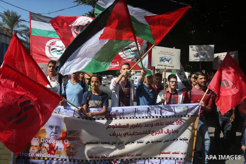 Palestinians hold banners during a demonstration in Gaza City to mark the anniversary of the Balfour Declaration on October 29, 2016. The 1917 Balfour Declaration is a formal statement of policy by the British government...
