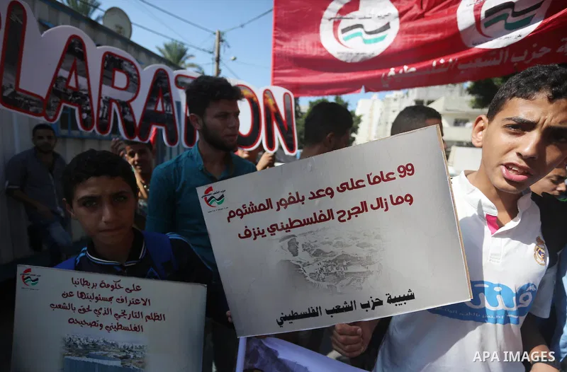 Palestinians hold banners during a demonstration in Gaza City to mark the anniversary of the Balfour Declaration on October 29, 2016. The 1917 Balfour Declaration is a formal statement of policy by the British government...