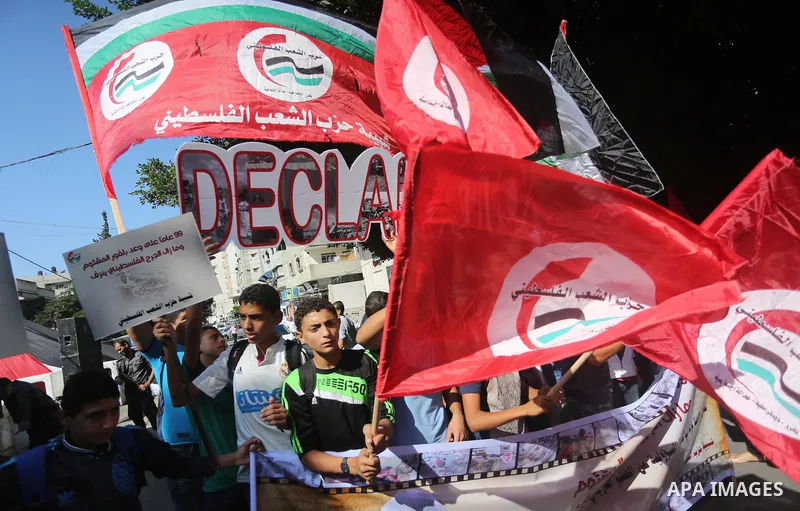 Palestinians hold banners during a demonstration in Gaza City to mark the anniversary of the Balfour Declaration on October 29, 2016. The 1917 Balfour Declaration is a formal statement of policy by the British government...