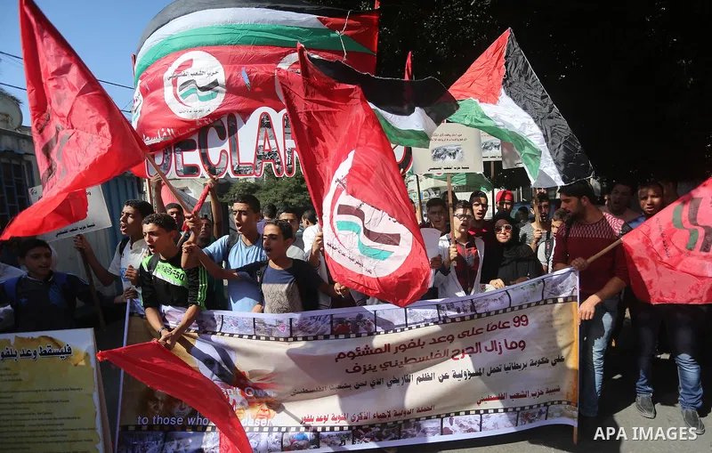 Palestinians hold banners during a demonstration in Gaza City to mark the anniversary of the Balfour Declaration on October 29, 2016. The 1917 Balfour Declaration is a formal statement of policy by the British government...