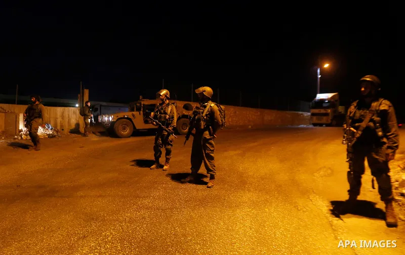 Israeli security forces stand guard near the scene where a Palestinian man was shot dead by Israeli troops at the in the West bank village of Beit Ommar, north of Hebron on October 30, 2016. The Palestinian driver Khaled...
