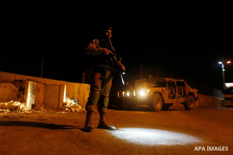 Israeli security forces stand guard near the scene where a Palestinian man was shot dead by Israeli troops at the in the West bank village of Beit Ommar, north of Hebron on October 30, 2016. The Palestinian driver Khaled...