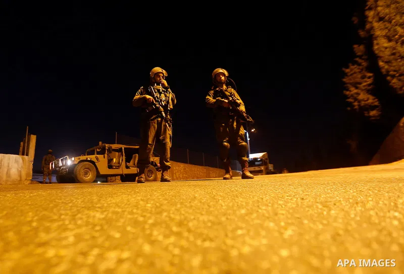 Israeli security forces stand guard near the scene where a Palestinian man was shot dead by Israeli troops at the in the West bank village of Beit Ommar, north of Hebron on October 30, 2016. The Palestinian driver Khaled...