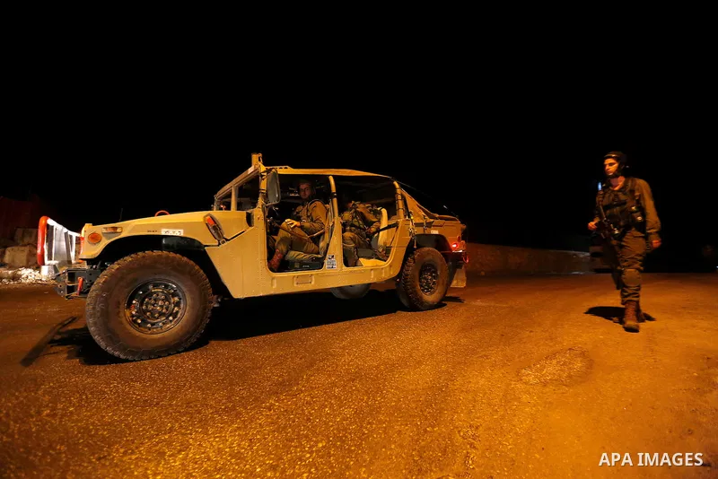 Israeli security forces stand guard near the scene where a Palestinian man was shot dead by Israeli troops at the in the West bank village of Beit Ommar, north of Hebron on October 30, 2016. The Palestinian driver Khaled...