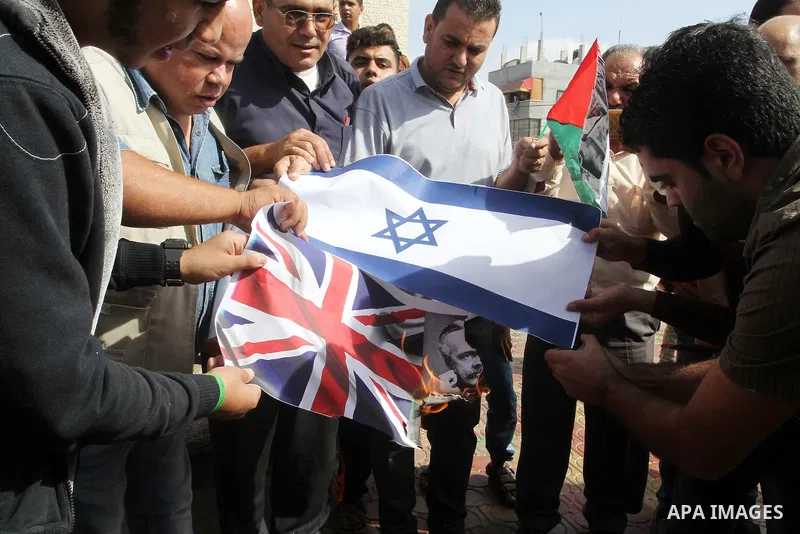 Palestinians burn Israeli and British flags during a demonstration to mark the anniversary of the Balfour Declaration, in Rafah in the southern Gaza strip, on November 1, 2016. The 1917 Balfour Declaration is a formal st...