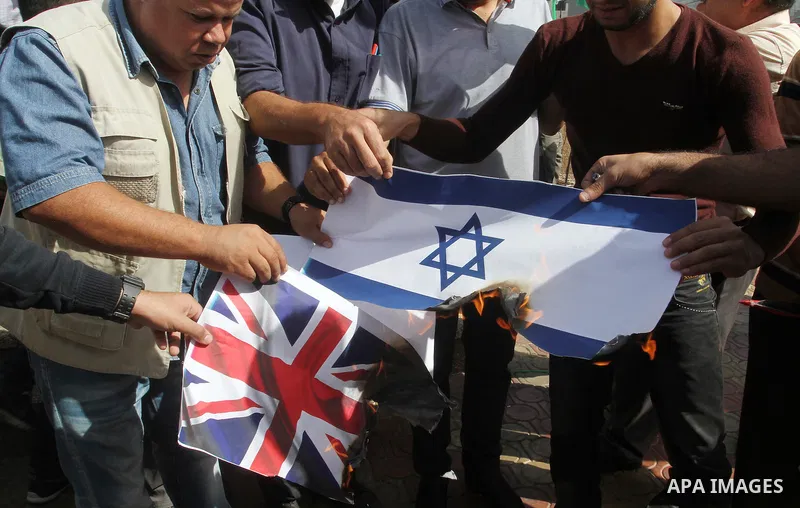Palestinians burn Israeli and British flags during a demonstration to mark the anniversary of the Balfour Declaration, in Rafah in the southern Gaza strip, on November 1, 2016. The 1917 Balfour Declaration is a formal st...