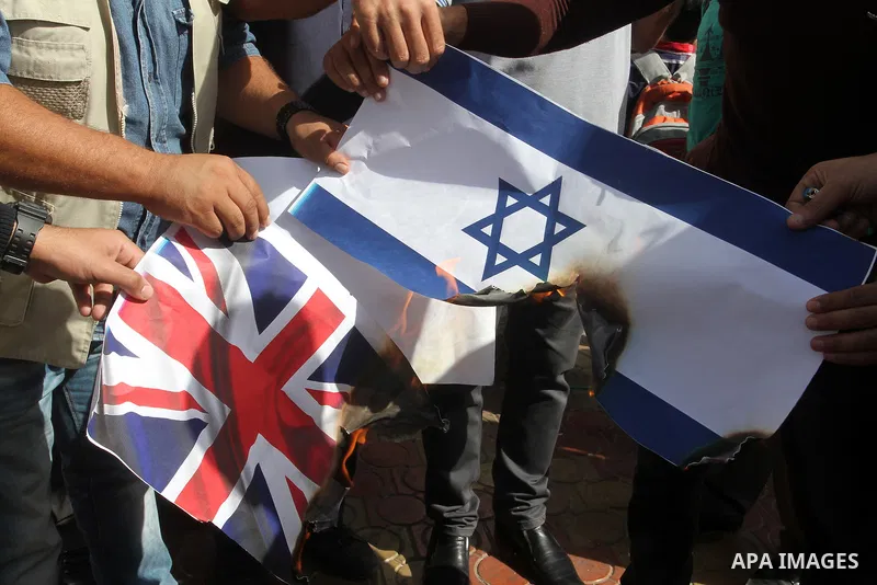 Palestinians burn Israeli and British flags during a demonstration to mark the anniversary of the Balfour Declaration, in Rafah in the southern Gaza strip, on November 1, 2016. The 1917 Balfour Declaration is a formal st...