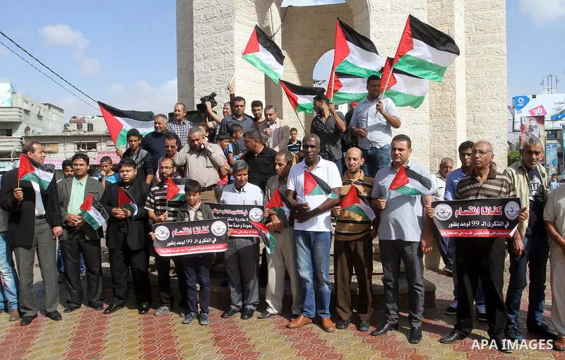 Palestinians hold banners during a demonstration to mark the anniversary of the Balfour Declaration, in Rafah in the southern Gaza strip, on November 1, 2016. The 1917 Balfour Declaration is a formal statement of policy...