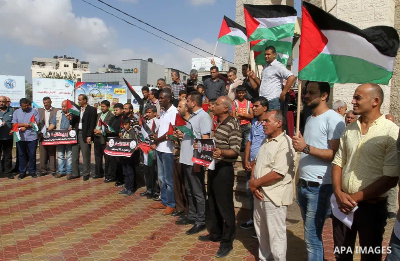 Palestinians hold banners during a demonstration to mark the anniversary of the Balfour Declaration, in Rafah in the southern Gaza strip, on November 1, 2016. The 1917 Balfour Declaration is a formal statement of policy...