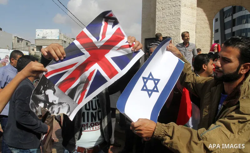 Palestinians burn Israeli and British flags during a demonstration to mark the anniversary of the Balfour Declaration, in Rafah in the southern Gaza strip, on November 1, 2016. The 1917 Balfour Declaration is a formal st...