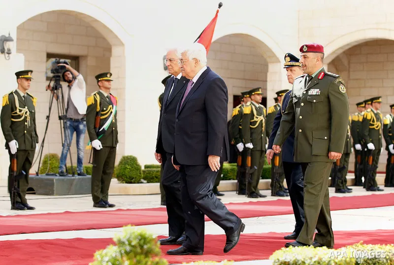 Palestinian President Mahmoud Abbas gestures as he welcomes Italy's President Sergio Mattarella during a welcoming ceremony in the West Bank city of Bethlehem November 1, 2016. Photo by Wisam Hashlamoun