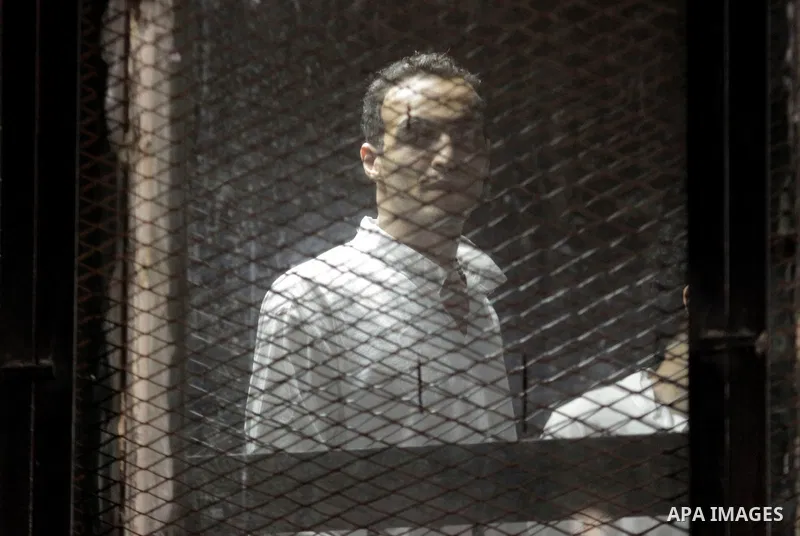 Egyptian Muslim Brotherhood defendants are seen behind bars during their trial, in a case known in media as "Rabaa Operations Room", in Cairo, on Nov. 1, 2016. Photo by Amr Sayed