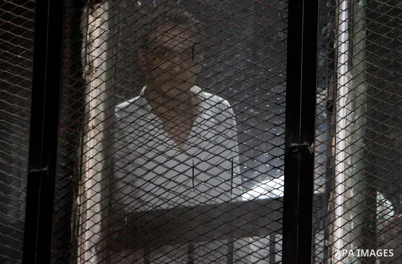 Egyptian Muslim Brotherhood defendants are seen behind bars during their trial, in a case known in media as "Rabaa Operations Room", in Cairo, on Nov. 1, 2016. Photo by Amr Sayed