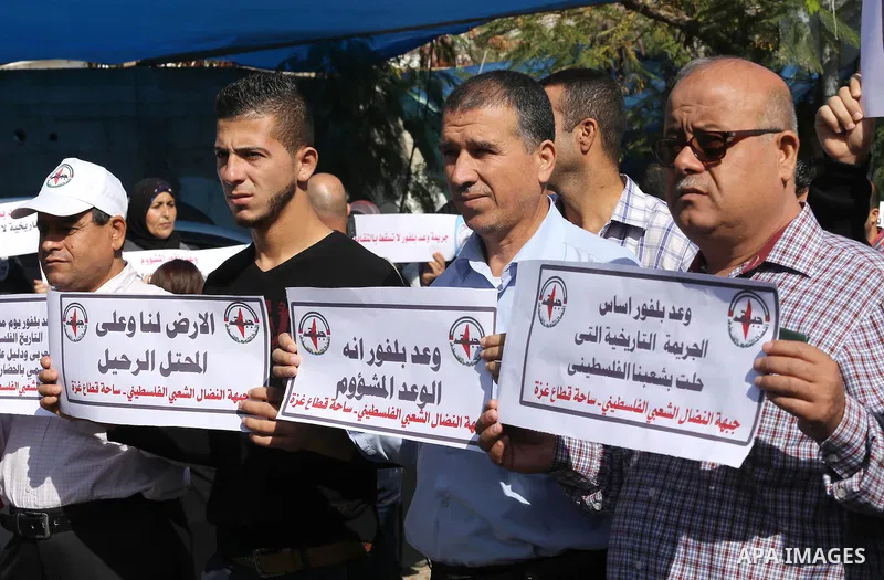 Palestinians hold banners during a demonstration to mark the anniversary of the Balfour Declaration, outside the UNESCO headquarters in Gaza city, on November 2, 2016. The 1917 Balfour Declaration is a formal statement o...