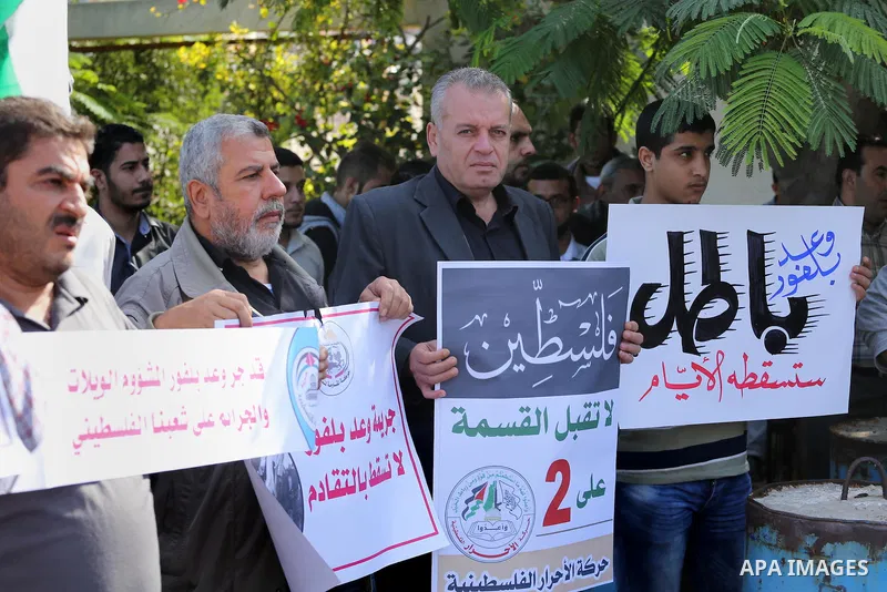 Palestinians hold banners during a demonstration to mark the anniversary of the Balfour Declaration, outside the UNESCO headquarters in Gaza city, on November 2, 2016. The 1917 Balfour Declaration is a formal statement o...