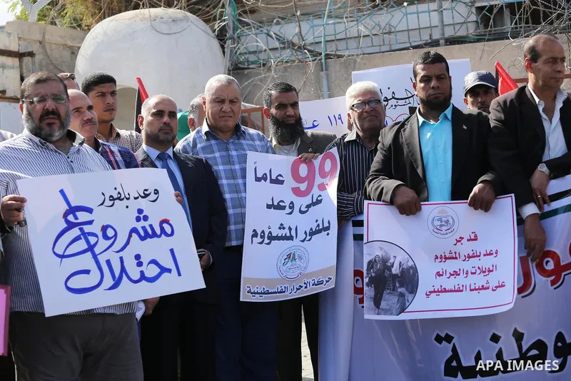 Palestinians hold banners during a demonstration to mark the anniversary of the Balfour Declaration, outside the UNESCO headquarters in Gaza city, on November 2, 2016. The 1917 Balfour Declaration is a formal statement o...