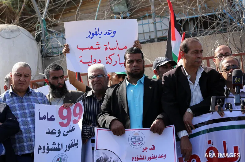 Palestinians hold banners during a demonstration to mark the anniversary of the Balfour Declaration, outside the UNESCO headquarters in Gaza city, on November 2, 2016. The 1917 Balfour Declaration is a formal statement o...