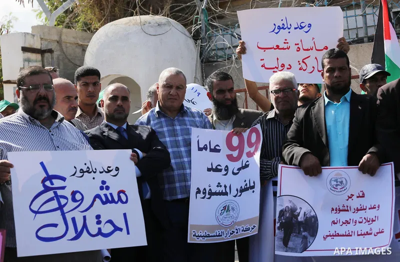 Palestinians hold banners during a demonstration to mark the anniversary of the Balfour Declaration, outside the UNESCO headquarters in Gaza city, on November 2, 2016. The 1917 Balfour Declaration is a formal statement o...