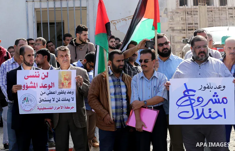 Palestinians hold banners during a demonstration to mark the anniversary of the Balfour Declaration, outside the UNESCO headquarters in Gaza city, on November 2, 2016. The 1917 Balfour Declaration is a formal statement o...