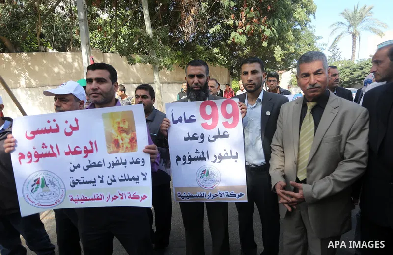 Palestinians hold banners during a demonstration to mark the anniversary of the Balfour Declaration, outside the UNESCO headquarters in Gaza city, on November 2, 2016. The 1917 Balfour Declaration is a formal statement o...