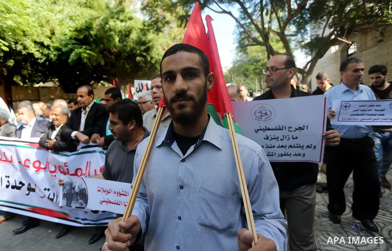 Palestinians hold banners during a demonstration to mark the anniversary of the Balfour Declaration, outside the UNESCO headquarters in Gaza city, on November 2, 2016. The 1917 Balfour Declaration is a formal statement o...