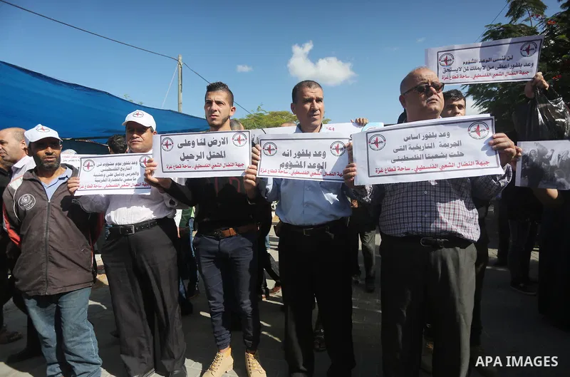 Palestinians hold banners during a demonstration to mark the anniversary of the Balfour Declaration, outside the UNESCO headquarters in Gaza city, on November 2, 2016. The 1917 Balfour Declaration is a formal statement o...