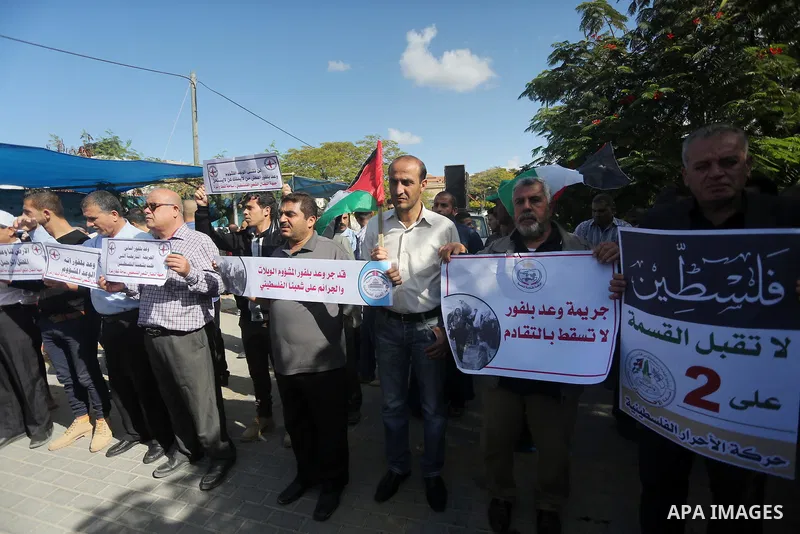 Palestinians hold banners during a demonstration to mark the anniversary of the Balfour Declaration, outside the UNESCO headquarters in Gaza city, on November 2, 2016. The 1917 Balfour Declaration is a formal statement o...