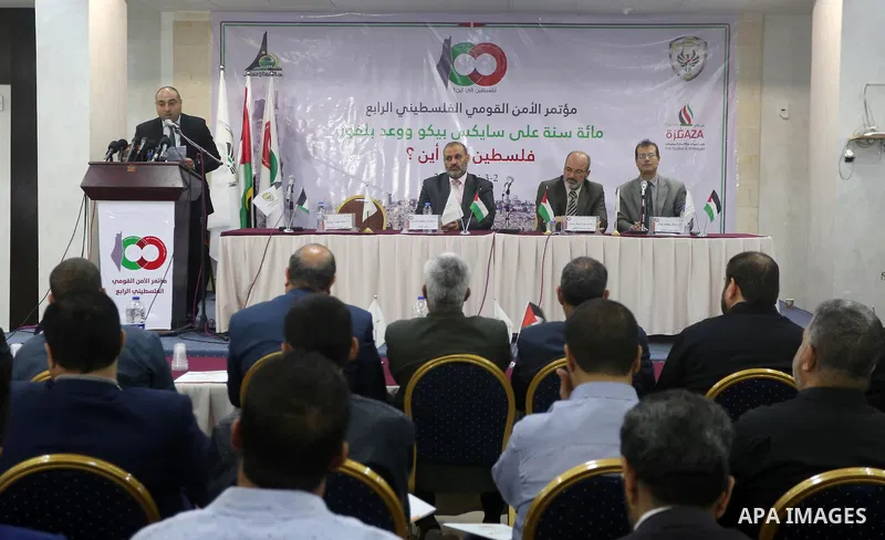 Palestinians attend the "Fourth National Security" conference organized by the Academy of Management and the political Graduate Studies, with the participation of the Hamas political leader Khaled Meshaal, via video conf...
