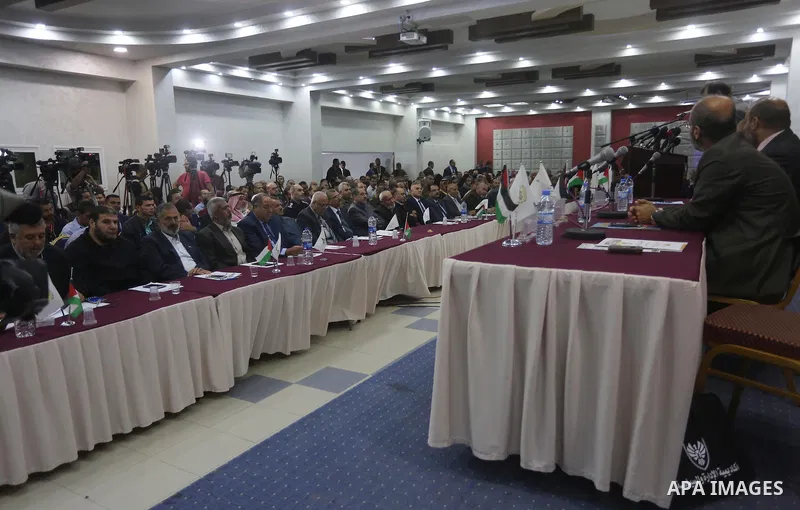 Palestinians attend the "Fourth National Security" conference organized by the Academy of Management and the political Graduate Studies, with the participation of the Hamas political leader Khaled Meshaal, via video conf...
