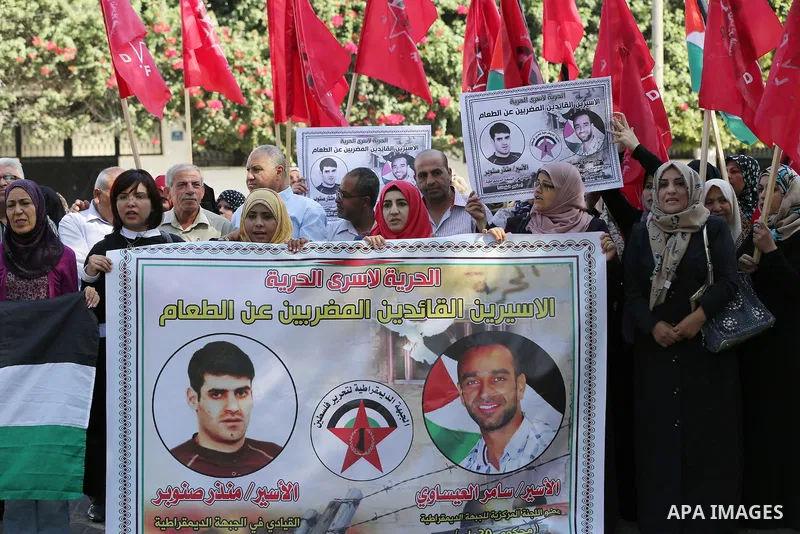 Palestinian supporters of the Popular Front for the Liberation of Palestine (PFLP), take part during a protest to show solidarity with Palestinian prisoners on hunger strike in Israeli Jails, in Gaza city on November 3,...