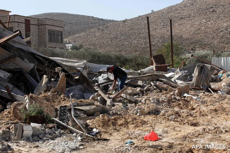 Palestinians inspect the rubble of barracks that was demolished after Israeli authorities said it was built without a permit in the village of Beita, south in the West Bank city of Nablus, on November 3, 2016. Photo by N...