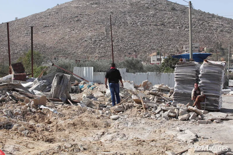 Palestinians inspect the rubble of barracks that was demolished after Israeli authorities said it was built without a permit in the village of Beita, south in the West Bank city of Nablus, on November 3, 2016. Photo by N...