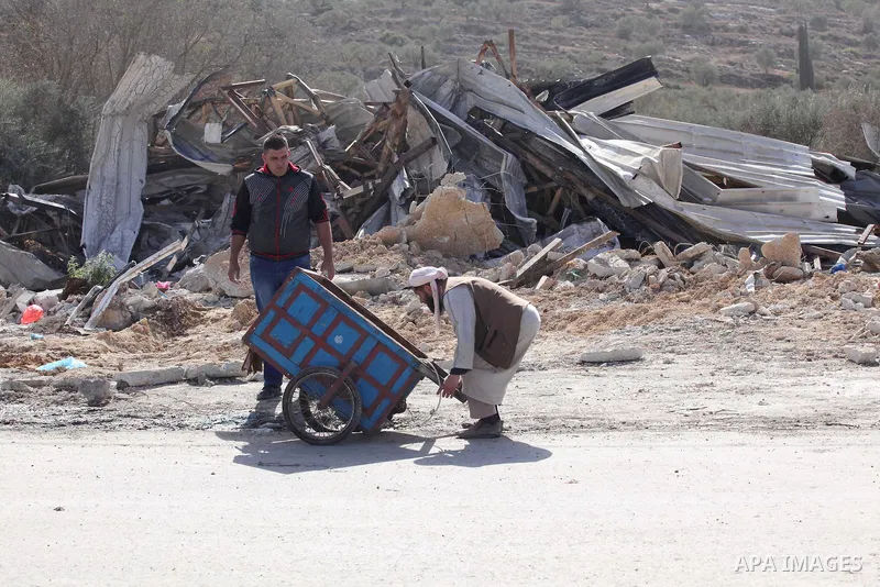 Palestinians inspect the rubble of barracks that was demolished after Israeli authorities said it was built without a permit in the village of Beita, south in the West Bank city of Nablus, on November 3, 2016. Photo by N...