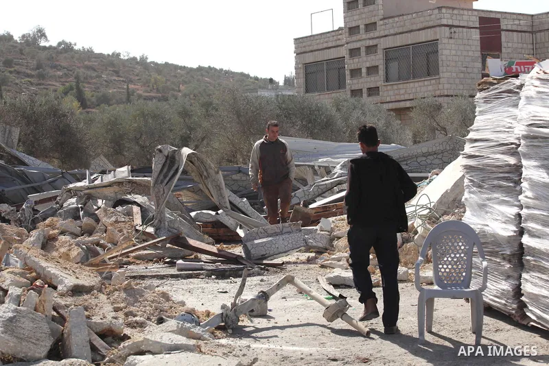 Palestinians inspect the rubble of barracks that was demolished after Israeli authorities said it was built without a permit in the village of Beita, south in the West Bank city of Nablus, on November 3, 2016. Photo by N...