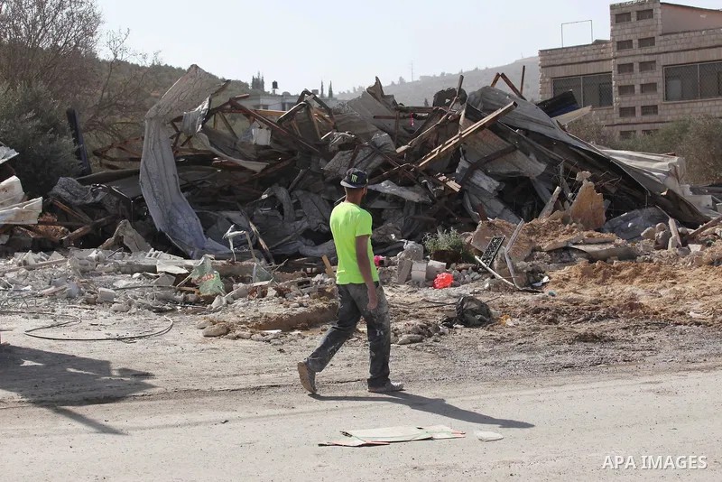 Palestinians inspect the rubble of barracks that was demolished after Israeli authorities said it was built without a permit in the village of Beita, south in the West Bank city of Nablus, on November 3, 2016. Photo by N...