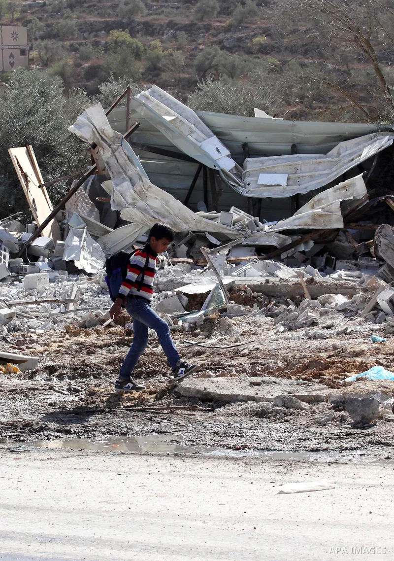 Palestinians inspect the rubble of barracks that was demolished after Israeli authorities said it was built without a permit in the village of Beita, south in the West Bank city of Nablus, on November 3, 2016. Photo by N...