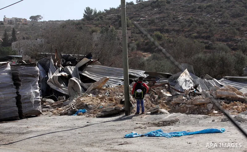 Palestinians inspect the rubble of barracks that was demolished after Israeli authorities said it was built without a permit in the village of Beita, south in the West Bank city of Nablus, on November 3, 2016. Photo by N...