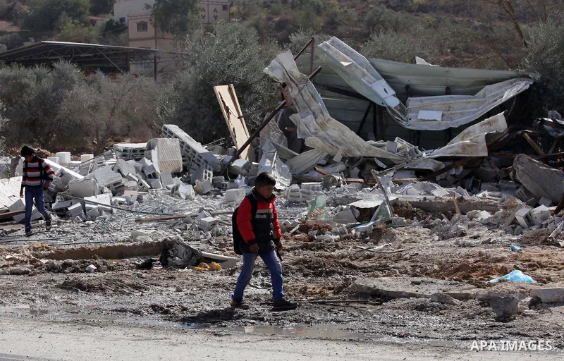 Palestinians inspect the rubble of barracks that was demolished after Israeli authorities said it was built without a permit in the village of Beita, south in the West Bank city of Nablus, on November 3, 2016. Photo by N...