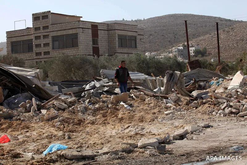 Palestinians inspect the rubble of barracks that was demolished after Israeli authorities said it was built without a permit in the village of Beita, south in the West Bank city of Nablus, on November 3, 2016. Photo by N...