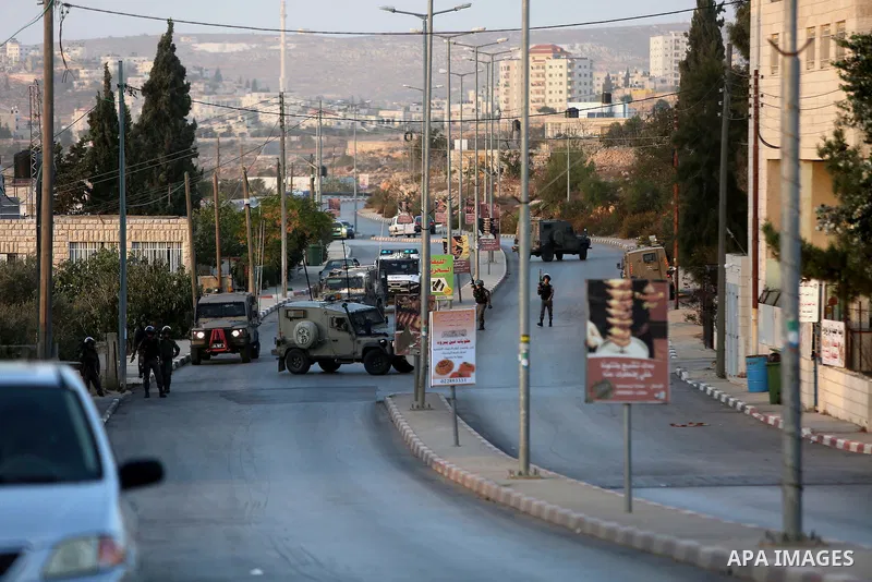 Members of Israeli security forces gather at the site where Israeli troops shot dead a Palestinian who attempted to stab a soldier near the West Bank settlement of Ofra on November 3, 2016. Photo by Shadi Hatem