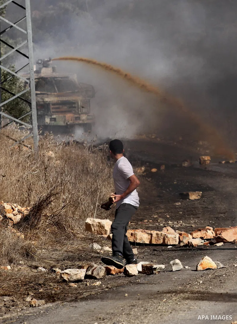 A Palestinian protester hurls stones towards Israeli security forces during clashes following a weekly demonstration against the expropriation of Palestinian land by Israel on Nov. 04, 2016, in the village of Kfar Qaddum...