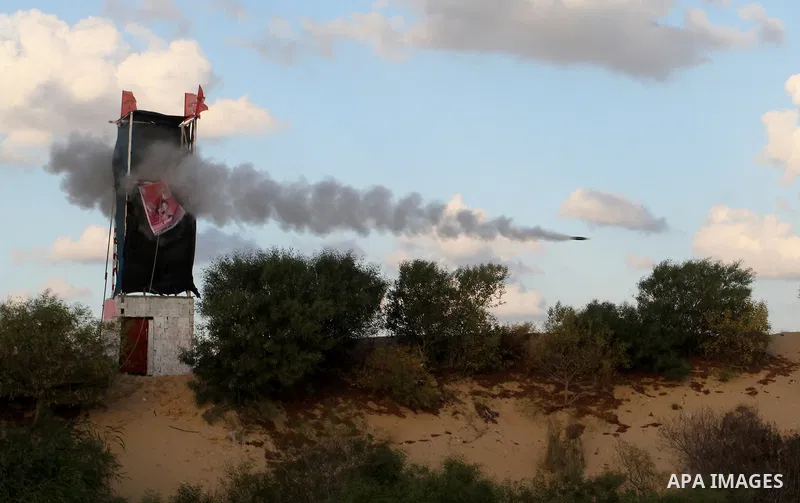 Palestinian militants of the National Resistance brigades, the armed wing of the Democratic Front for the Liberation of Palestine (DFLP), fire a rocket during a graduation ceremony in Rafah, in the southern Gaza Strip, o...