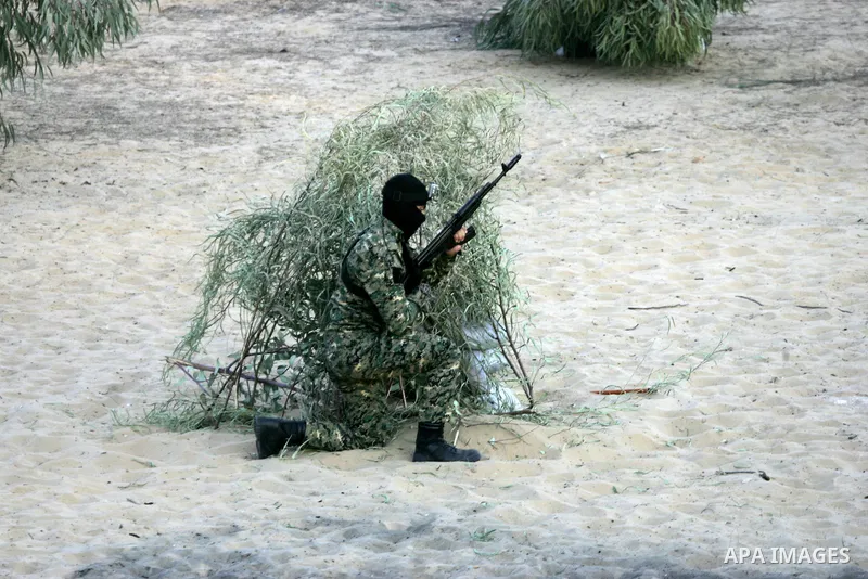 A Palestinian militant of the National Resistance brigades, the armed wing of the Democratic Front for the Liberation of Palestine (DFLP) takes a position during a graduation ceremony in Rafah in the southern Gaza Strip...